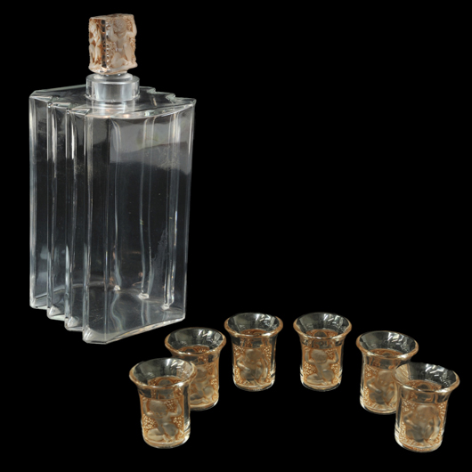 Lalique France ‘Enfants’ art glass decanter and six cordials. Estimate: $900-$1,800. Image courtesy of Morton Kuehnert Auctioneers & Appraisers.